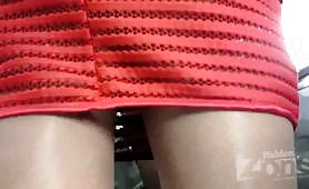 Under the skirt of a slender blonde in a short red skirt